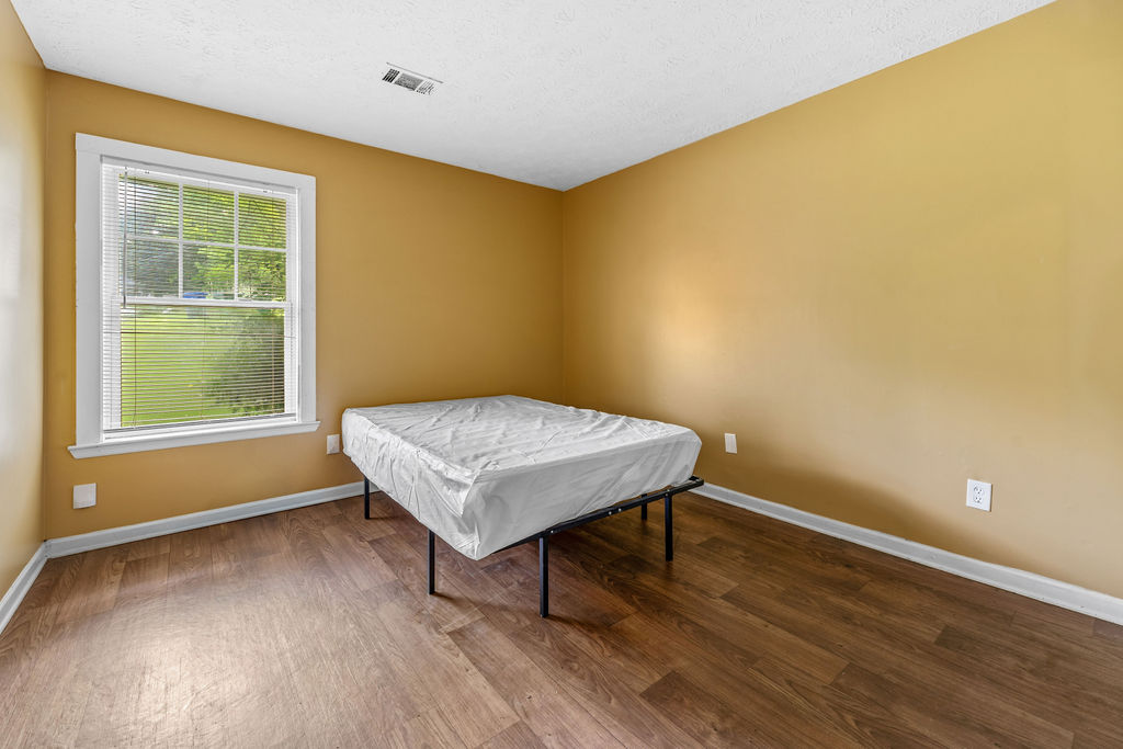 Bedroom with warm yellow walls and window