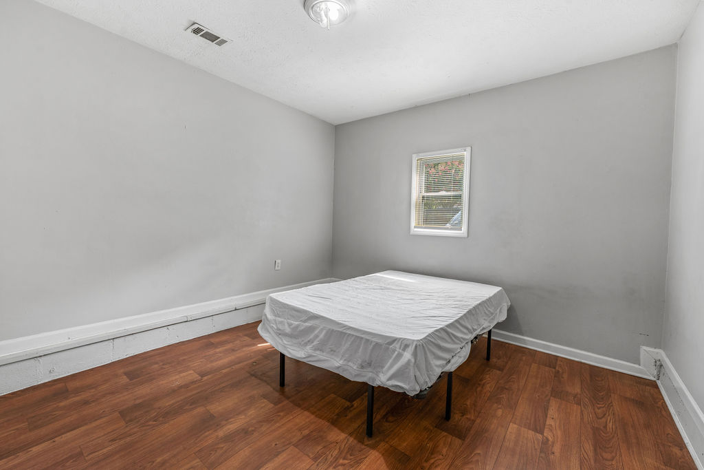 Bedroom with window and bed frame