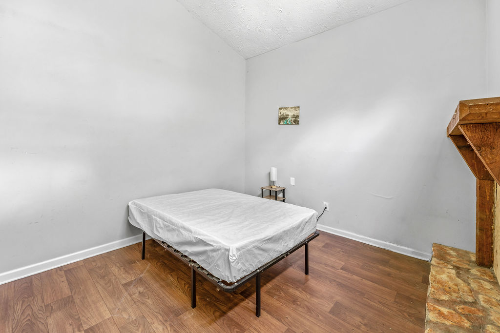 Bedroom with high ceiling and bed frame