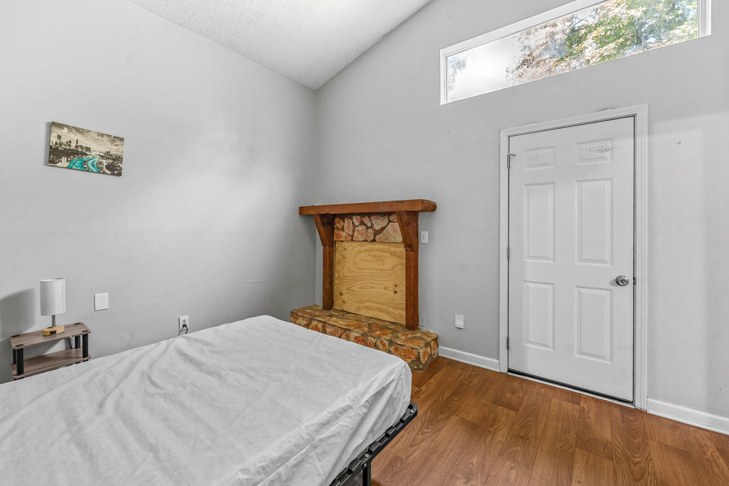 Bedroom with stone fireplace and private exterior door